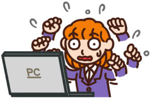 パソコンの前で困ったことがあり焦っている　イメージ画像